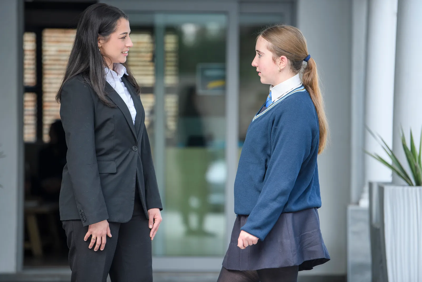 An Education Leader listening to a school student outside reception