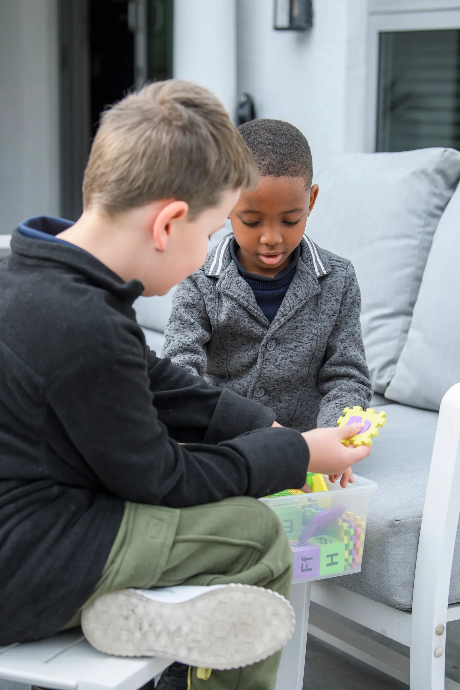 A young learner exploring a colourful learning block with a peer
